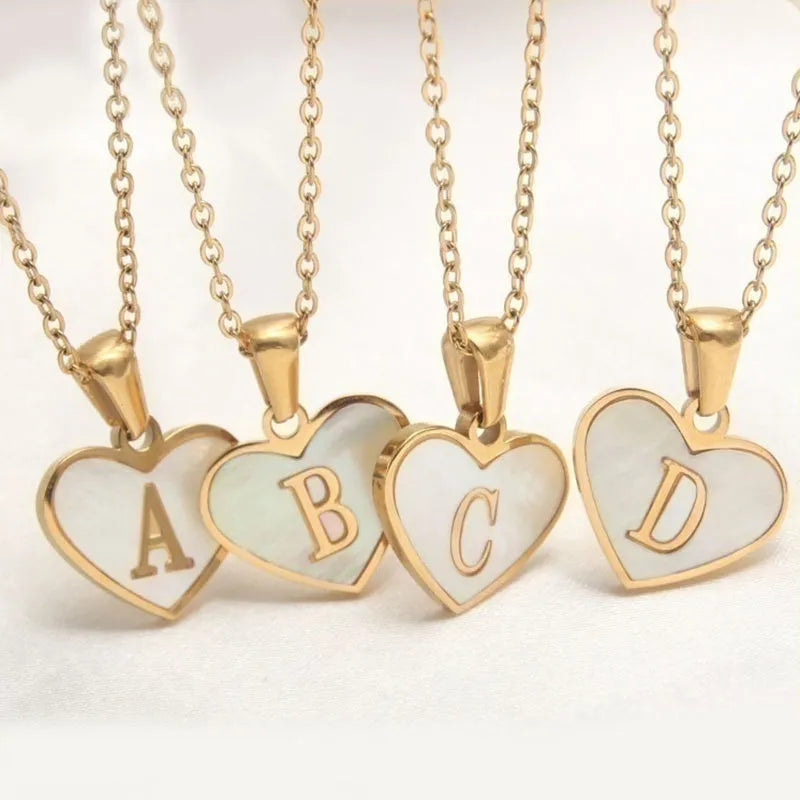 Gold-plated heart-shaped white shell pendant necklace on a stainless steel chain with extendable clasp
