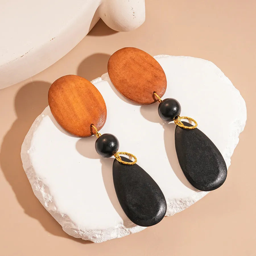 Handmade wooden retro earrings with elliptical shape in silver needle-brown-black colour combination