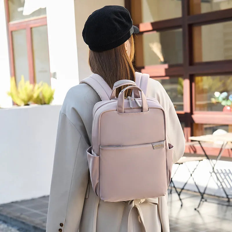 Large canvas travel backpack in apricot colour showing external pocket and urban style.