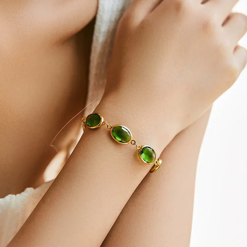 Geometric copper bracelet with glass inlay in blue, green, and multicolor options showing ellipse design elements