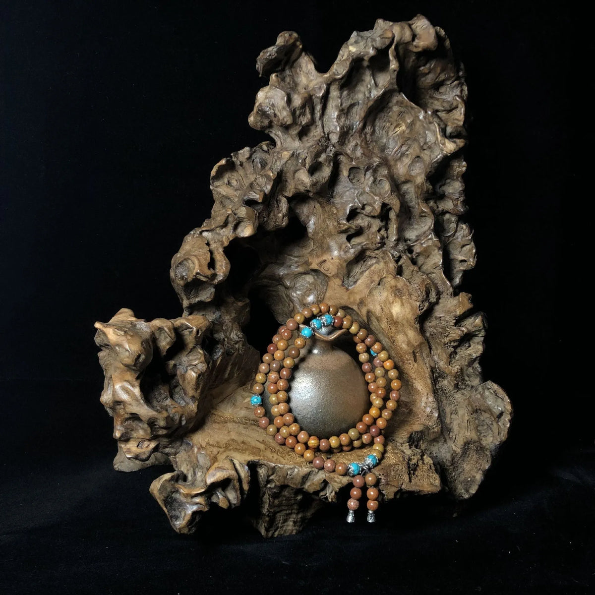 Handmade stone bead bracelet with 108 round geometric beads on a wrist.
