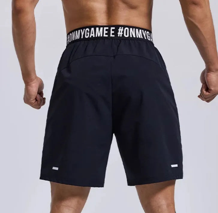 Men's black elastic waist sports shorts with cropped length for workouts