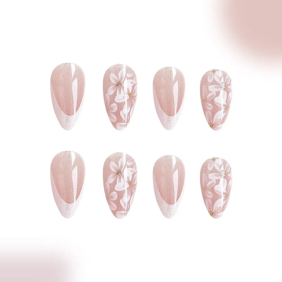 Short almond-shaped false nails with French style base and glitter powder flower decoration, colour C625.