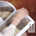 Women's freshwater pearl bracelet with fan-shaped design and elastic or chain fastening options