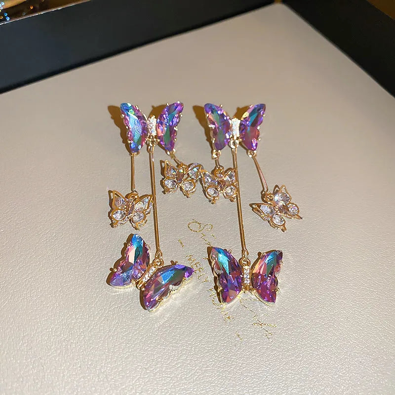 Blue purple butterfly tassel earrings with silver crystal flowers on alloy settings.