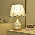 Crystal desk lamp with iron art base in gold finish on wooden table