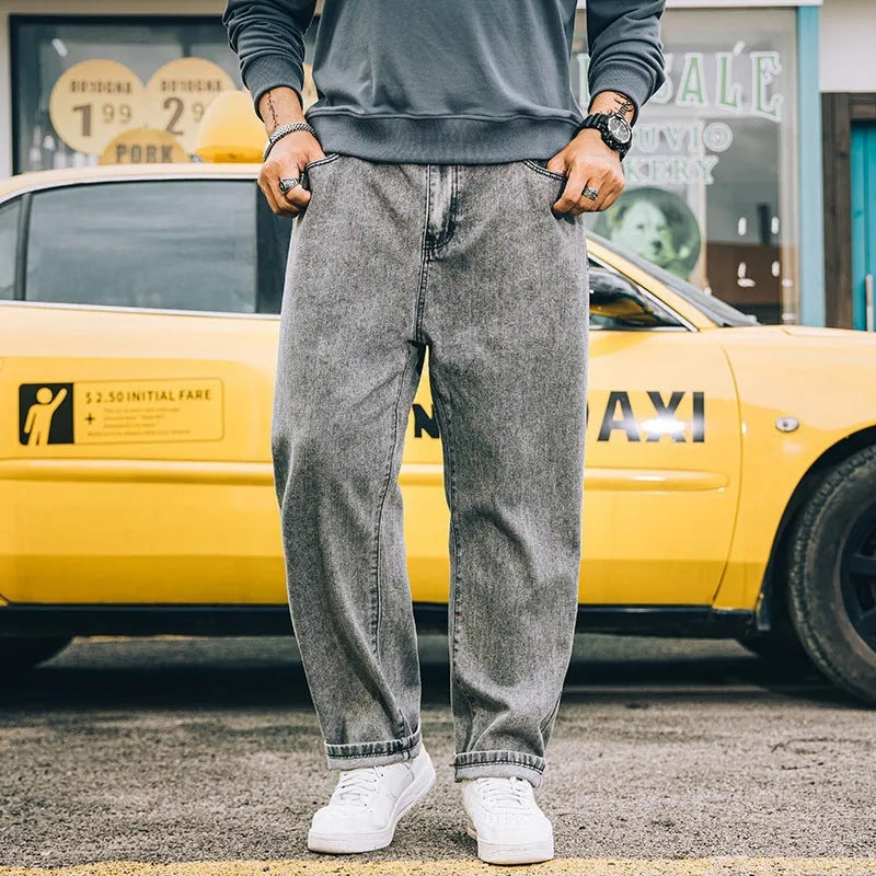 Men's loose straight leg jeans in dark blue cotton denim with a mid-rise waist and zipper fly