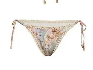 Creamy white women's floral bikini set with top, briefs, and matching skirt on a mannequin.