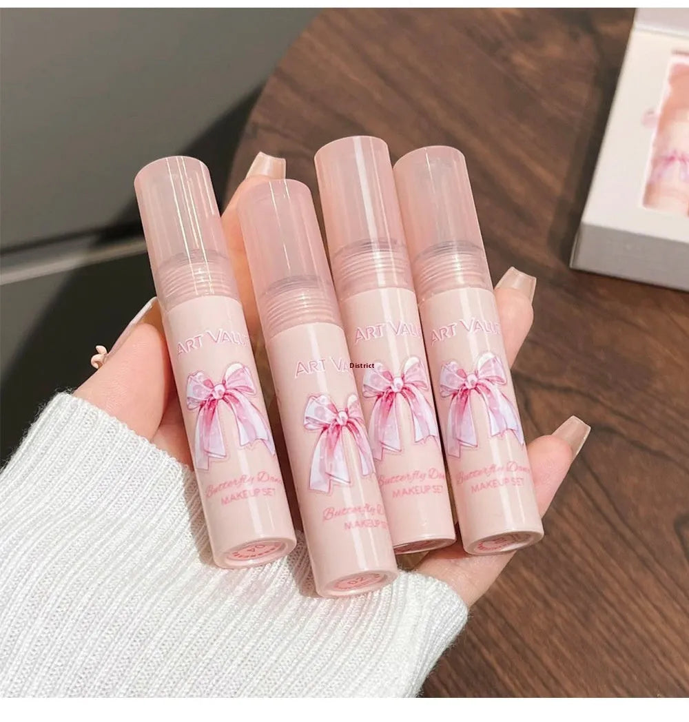 Butterfly Box makeup set containing four pink matte lip muds, one powder blusher, and a butterfly necklace in standard packaging.