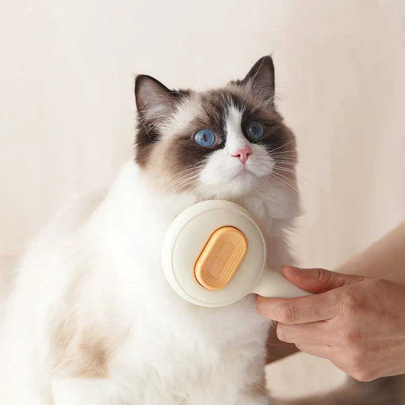 Yellow stainless steel cat grooming brush with non-slip handle for hair removal.