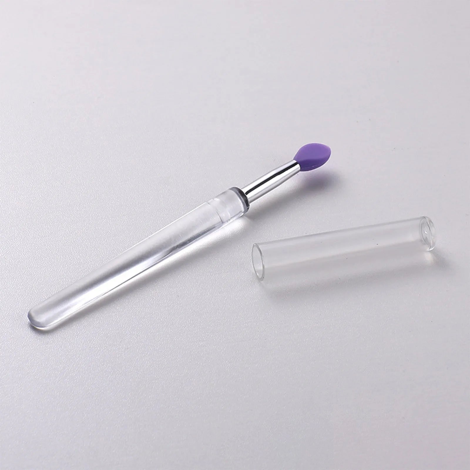 Set of reusable silicone lip brushes with protective caps in eight different colours.