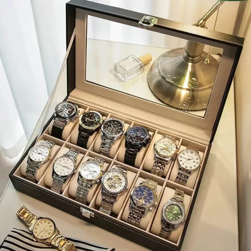 Grey leather watch storage box with transparent lid showing internal watch slots.