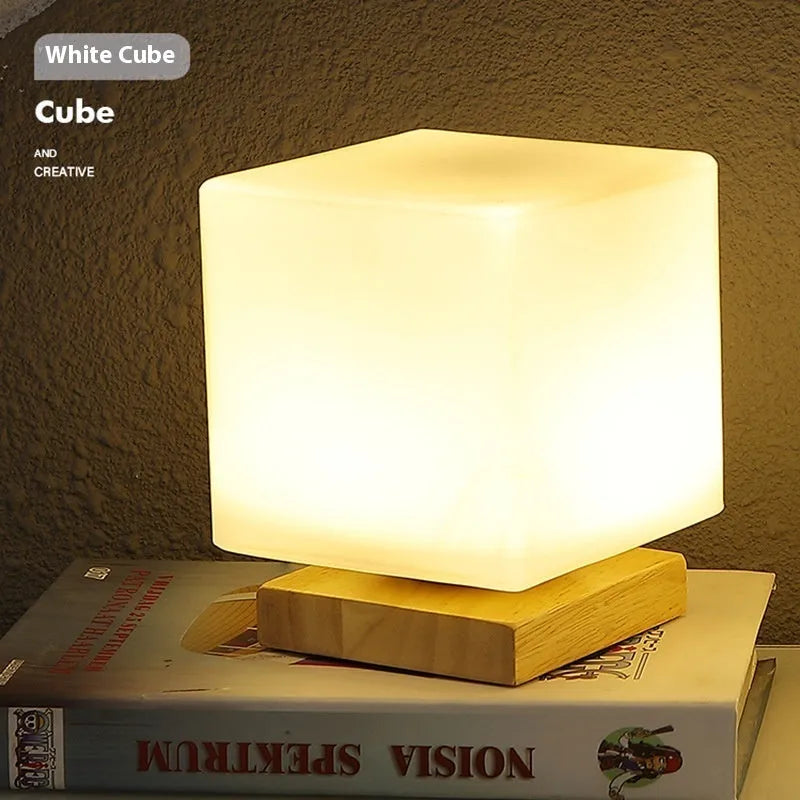 Nordic solid wood flower-shaped USB table lamp with touch dimming in a white cube style on a table