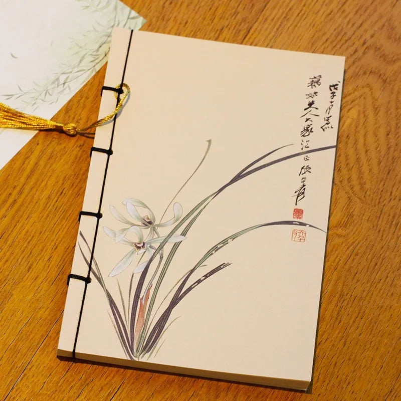 A5 antique wire-bound notebook with glossy embossed cover featuring a retro painting design, shown open.