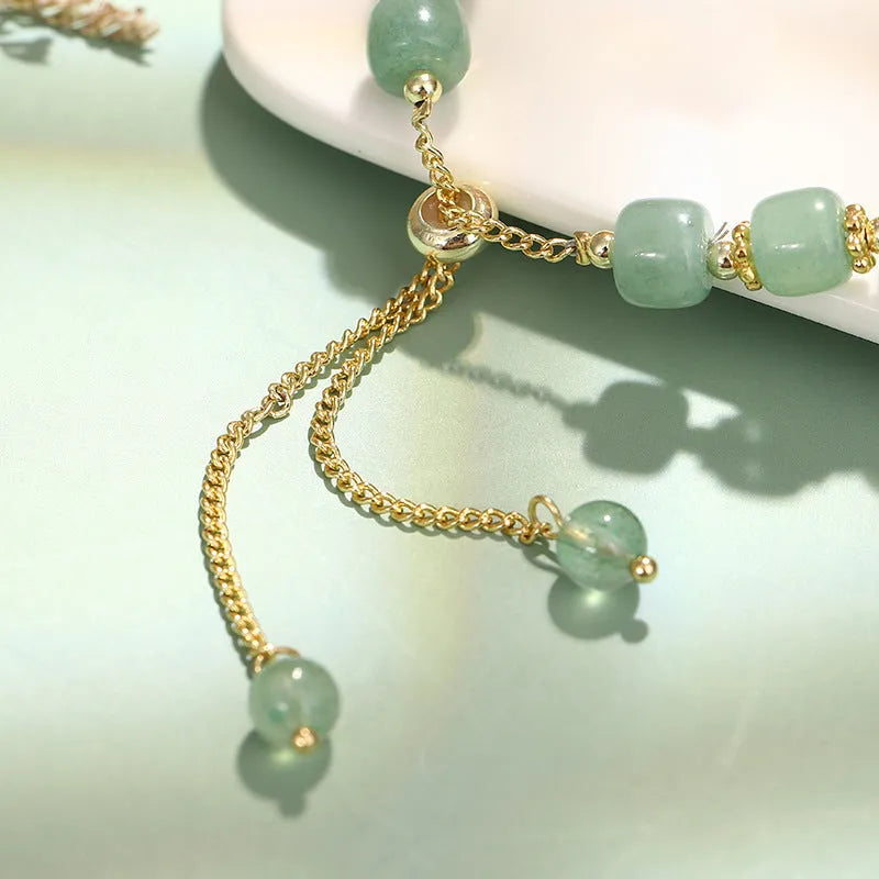 Rabbit charm bracelet with natural stone beads on copper-plated chain with gold accents