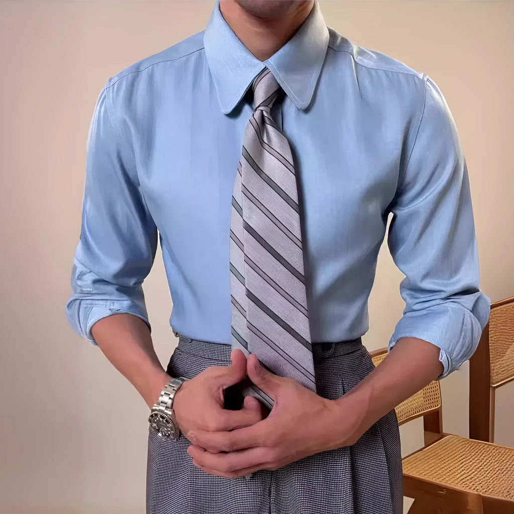 Man wearing a slim fit blue round collar long sleeve shirt made from a rayon and polyester blend.