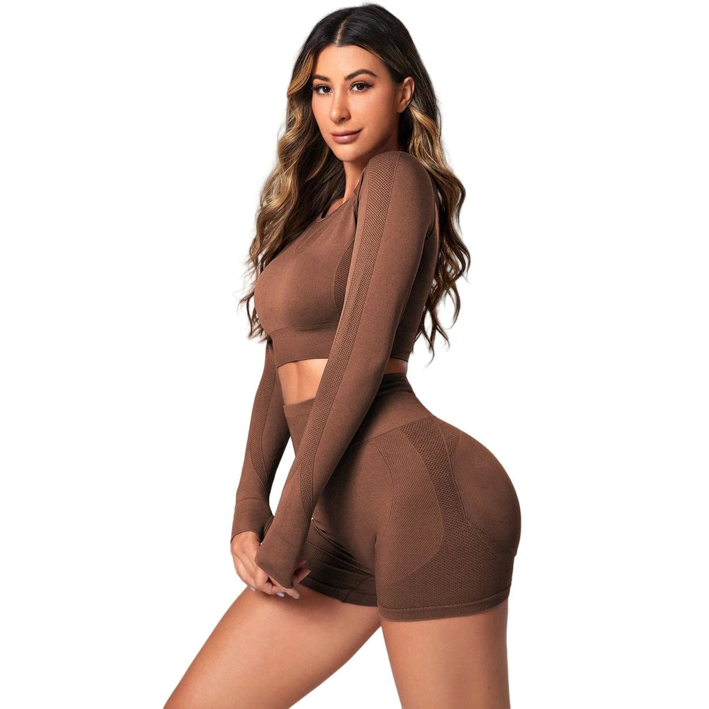 Women's black high-waist yoga suit with long sleeve top and tight-fit pants laid flat.