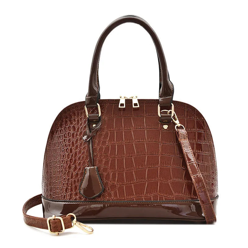 Large shiny PU leather crossbody bag in shell shape design showing black colour option