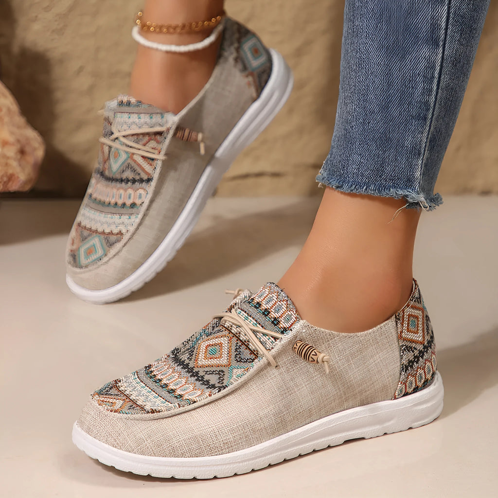 Women's black flat casual shoes with round toe and low-top design on a neutral background