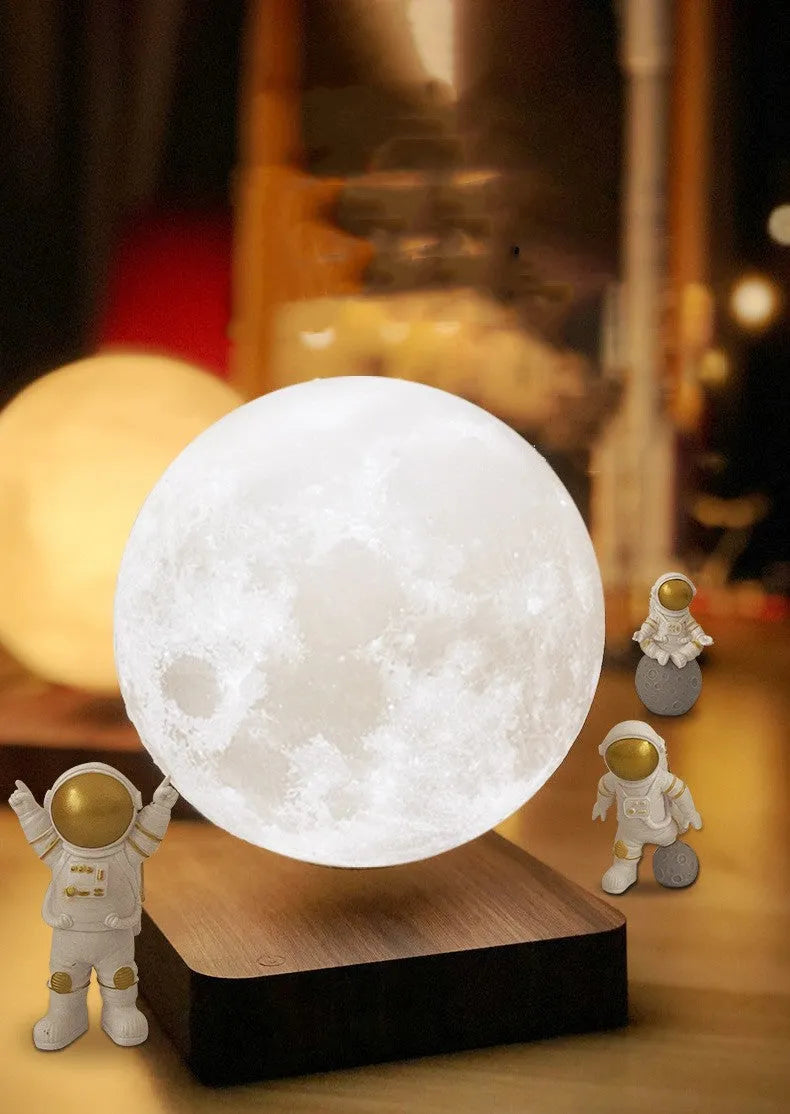 Maglev floating planet night light with LED glow and astronaut figurines on a dark surface.