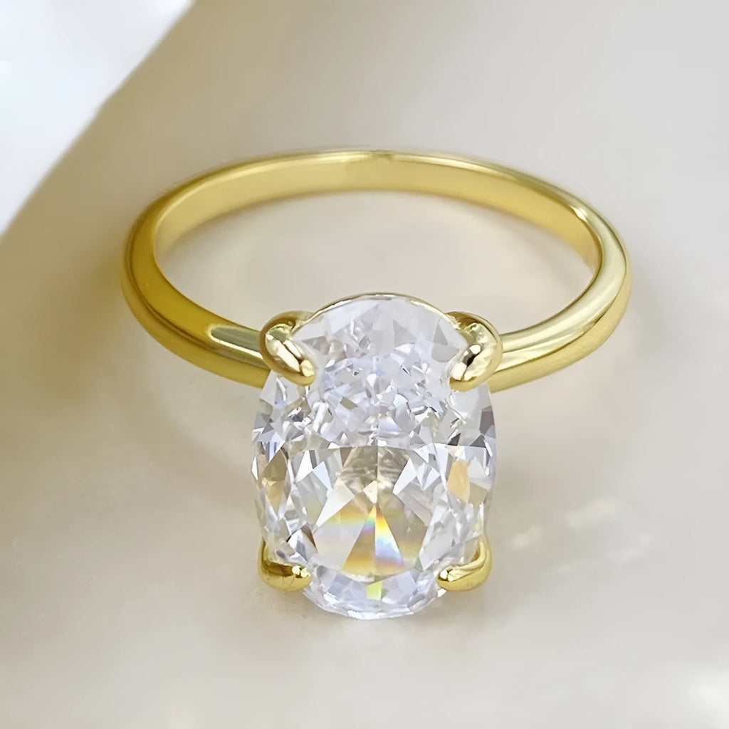 Oval women's ring with four-claw setting holding a 6x9mm gemstone on a silver band