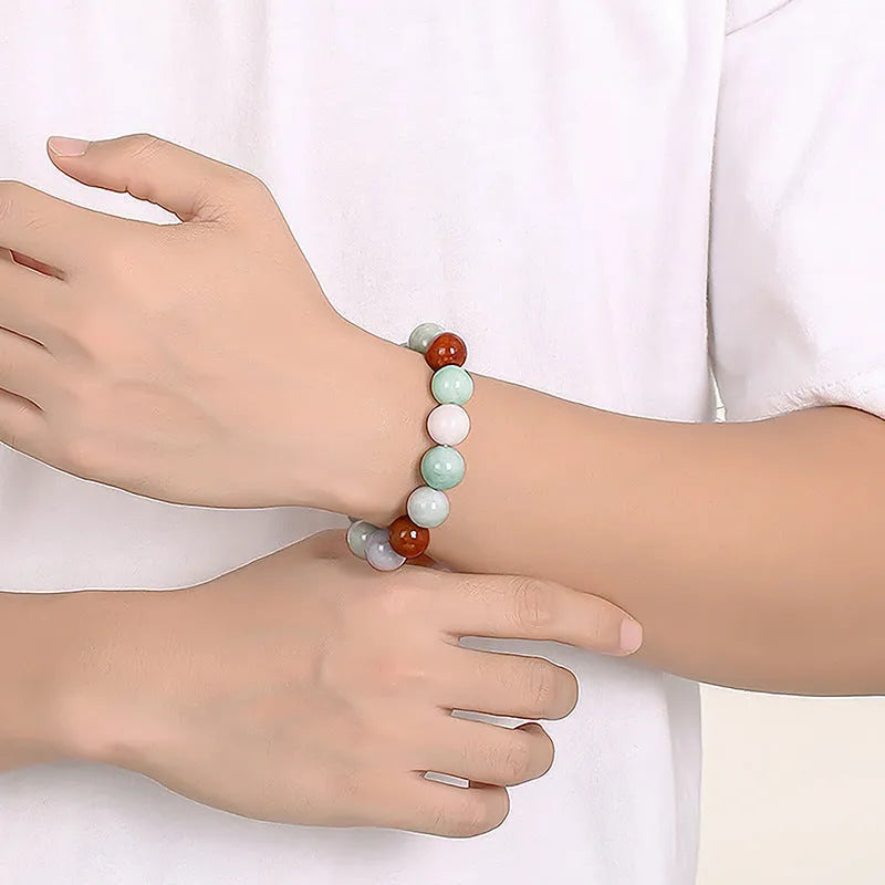 Natural Myanmar jade bracelet with three colours on 13mm round beads showing traditional craftsmanship