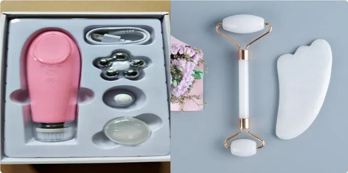 White jade facial roller and gua sha scraper board set on a plain surface.