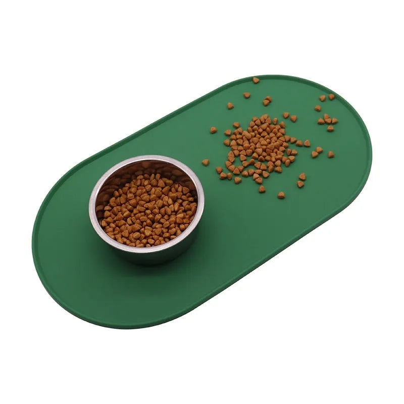 Silicone waterproof cat feeding placemat in green, shown under a food bowl.