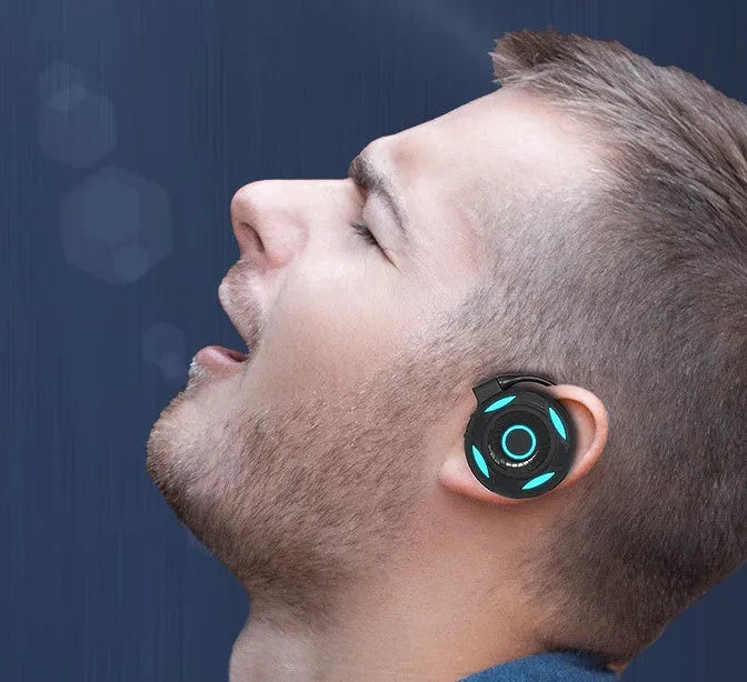 Black Bluetooth gaming earphones with hanging ear type design and USB charging cable
