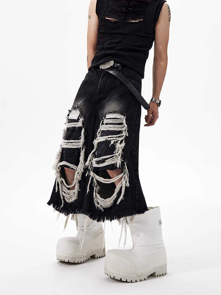 Women's black cropped wide leg jeans with distressed ripped patches and high waist