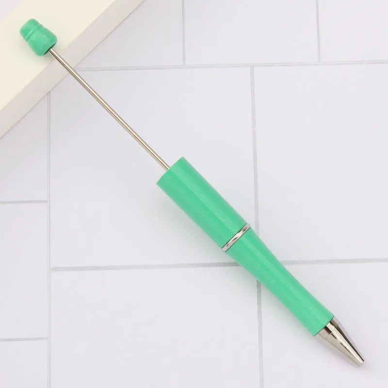 Ballpoint pen with colourful spinning plastic beads on barrel, shown in a gradient purple finish.