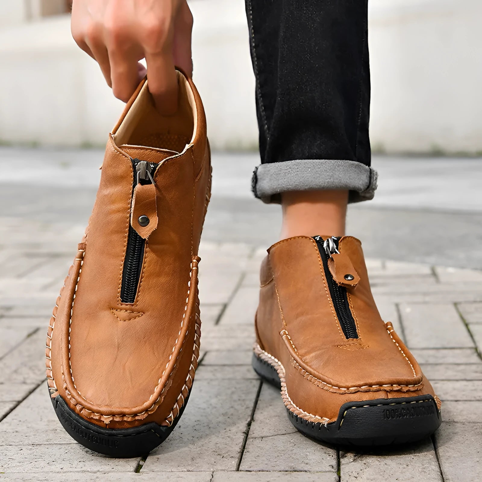 Men's black slip-on loafers with a round toe and rubber sole, shown in a casual style.