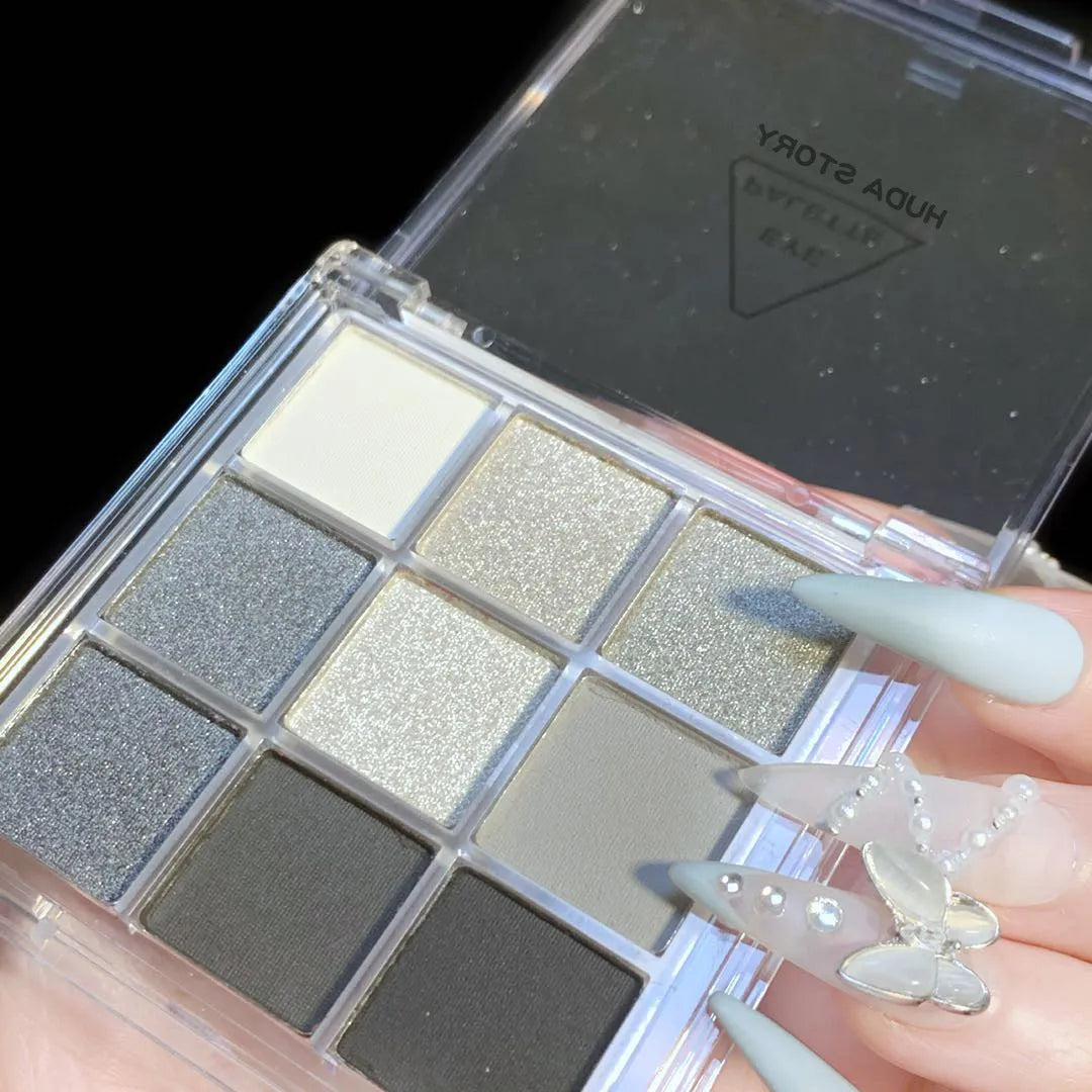 INS-style nine-color eyeshadow palette open, showing white, silver, black, and iron grey pressed powder shades.