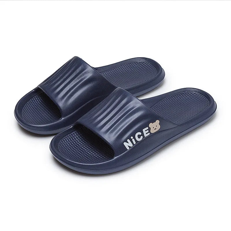 Pair of adult EVA flip flop slippers with a cartoon pattern on a non-slip sole, shown in one of six available colours.