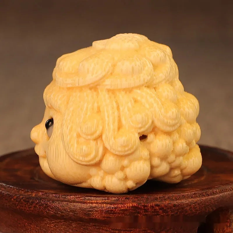 Golden Toad Princess ornament carved from solid bamboo on a wooden surface.