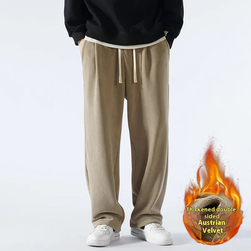 Man wearing loose apricot fleece-lined sports trousers with a drawstring waistband.
