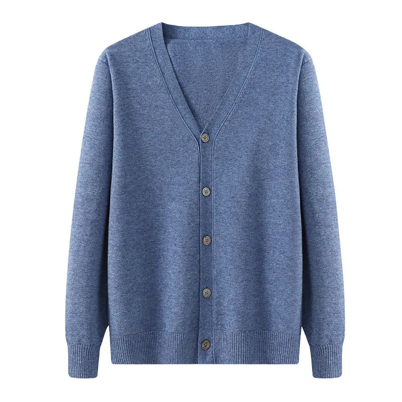 Man wearing a dark blue V-neck Andy velvet knitted cardigan with long sleeves.