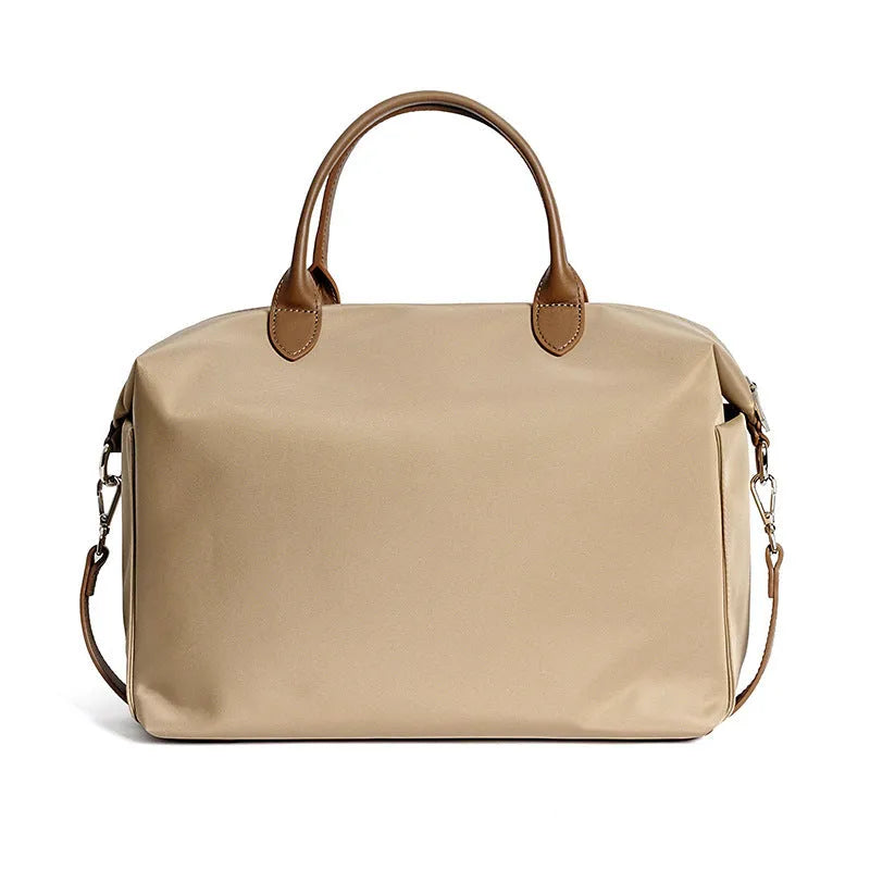Waterproof nylon shoulder bag with leather trims in black or light khaki colour, showing 35cm dimensions