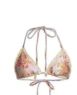 Creamy white women's floral bikini set with top, briefs, and matching skirt on a mannequin.