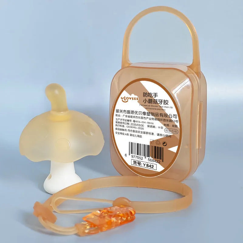 Small mushroom-shaped latex chewable gum on a transparent chain next to a clear storage box.