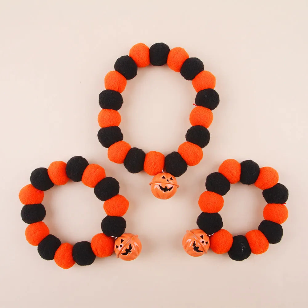 A pumpkin-themed adjustable cat collar for Halloween, shown in three sizes.