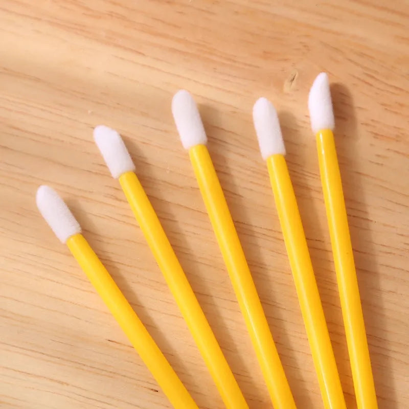 Pack of multi-colour disposable lip brush applicators with black handles and soft flocked tips.