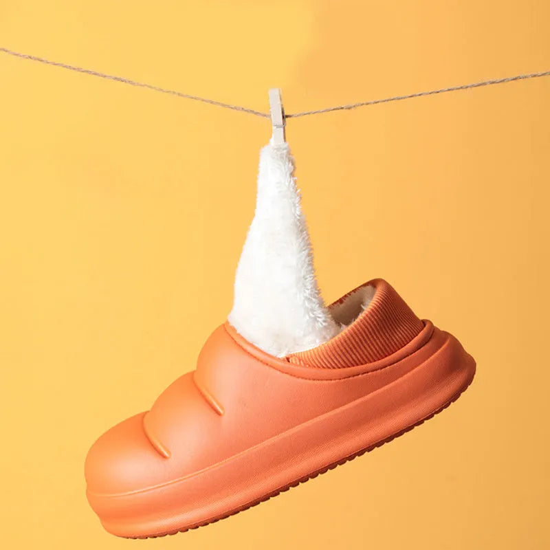 A pair of waterproof EVA couple slippers with a warm plush lining, shown in a green colour option.