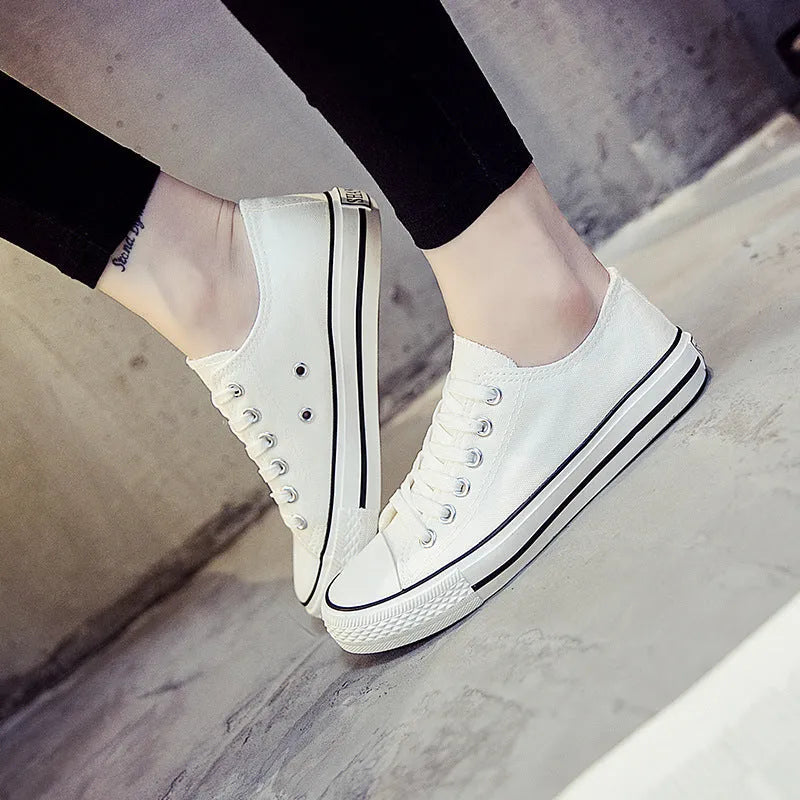 Women's solid colour canvas shoes in black, white and red colourways with casual design