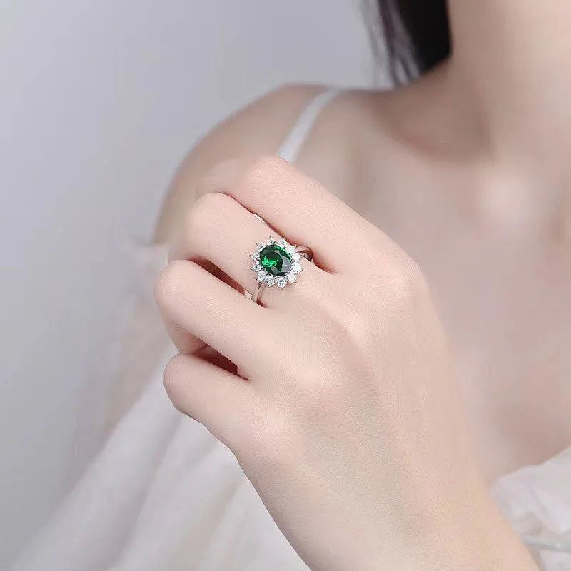 Copper flower-shaped ring with inlaid zirconia available in sapphire blue, green, and pomegranate red colours.