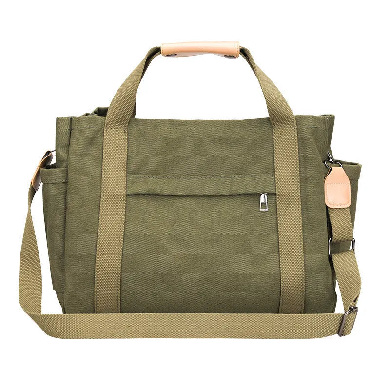 Large horizontal square canvas tote bag with crossbody strap and multiple internal pockets.