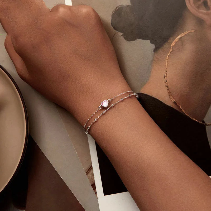 Women's 925 sterling silver bracelet with small heart-shaped pendant on an adjustable chain.