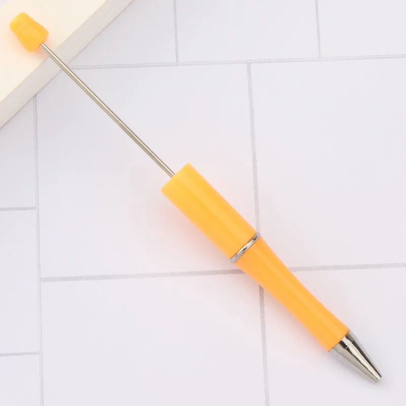 Ballpoint pen with colourful spinning plastic beads on barrel, shown in a gradient purple finish.