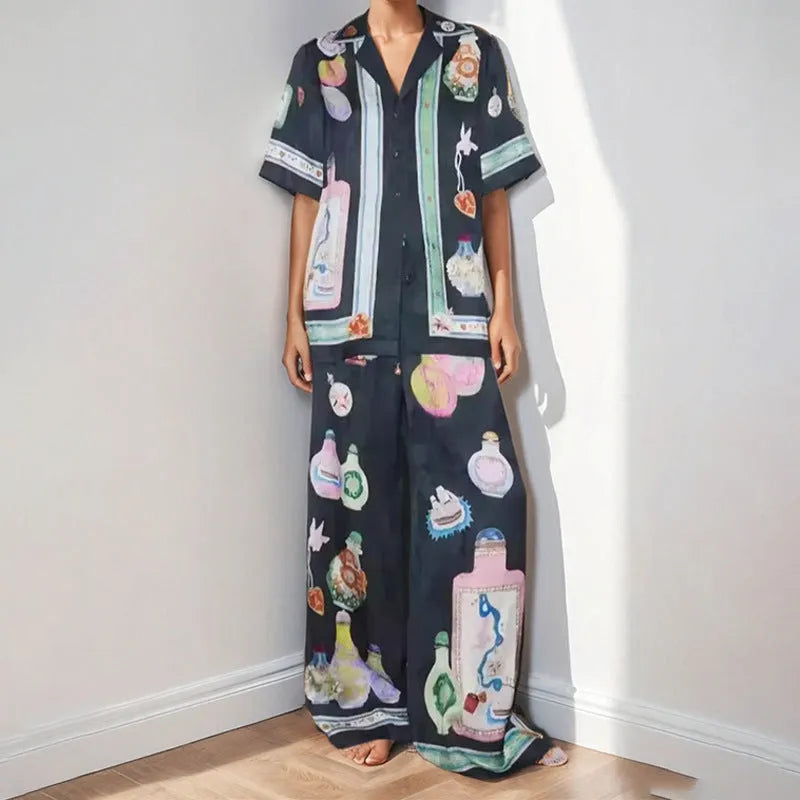 Women's black cardigan set with cartoon pattern, includes top and trousers