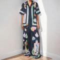 Women's black cardigan set with cartoon pattern, includes top and trousers